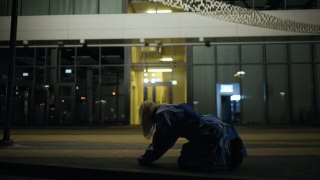 Exhausted medical intern crying in front of hospital after death of patient