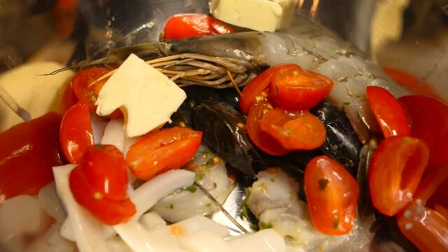 Adding butter cubes to seafood pasta cuisine delicacy closeup