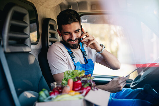Young and handsome Hispanic male working in daily home delivery service. He is positive and smiled.