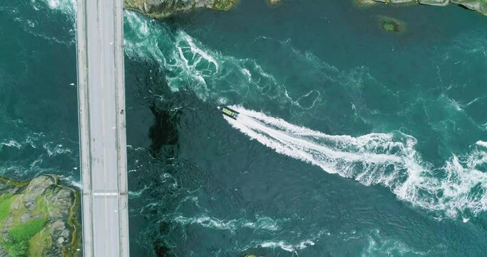 Group of tourists riding through famous Saltstraumen maelstrom in zodiac boat