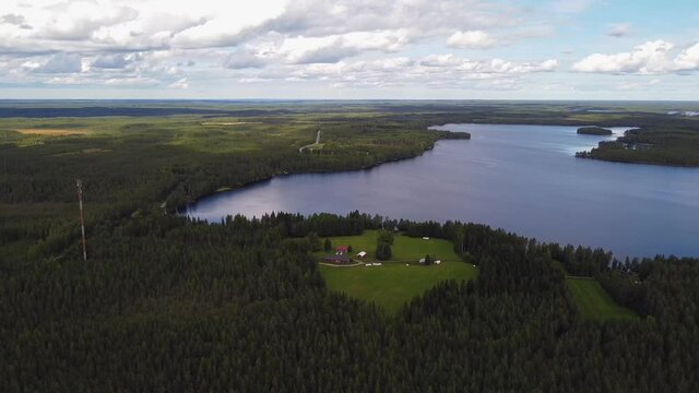 Remote homestead in the middle of green forest by Tornio river, finland, orbital aerial