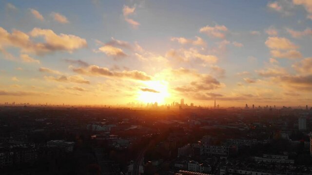 Dolly back drone shot of beautiful sunrise over London skyline