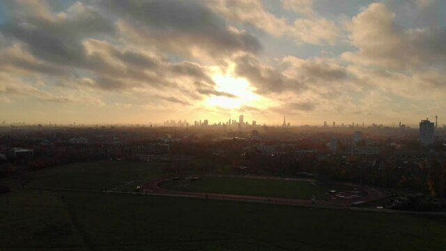 slider drone shot of beautiful sunrise over London skyline from Hampstead heath