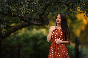 Young girl in retro dress posing in nature.