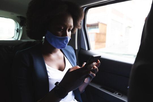 African American Woman Wearing Face Mask In Car