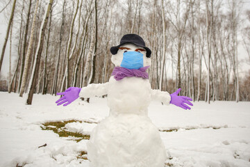 snowman in a hat, medical mask and gloves