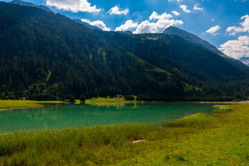Durlassboden reservoir in the Zillertal Alps, mountain lake with reflection in austria