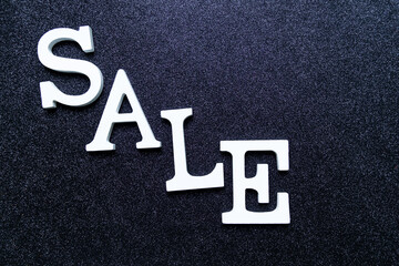 White letters SALE on black glitter background. black friday, cyber monday and seasonal sales banner 