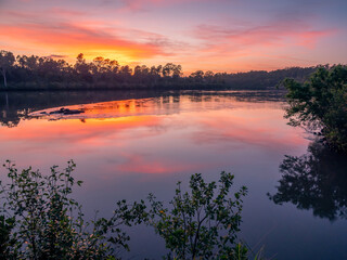 Beautiful Riverside Sunrise with Cloud Reflections