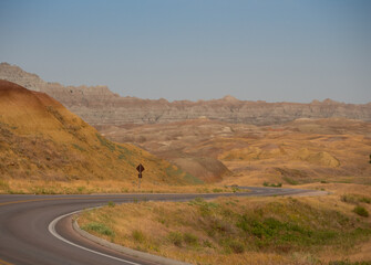 Yellow Hillsides with Highway in Badlands National Park with a highway winding through the photo.