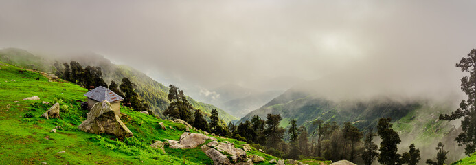 Panoramic view from Triund hill top at Mcleod ganj, Dharamsala, Himachal Pradesh, India. Triund hill top offers view of himalyan peaks of Dhauladhar range.