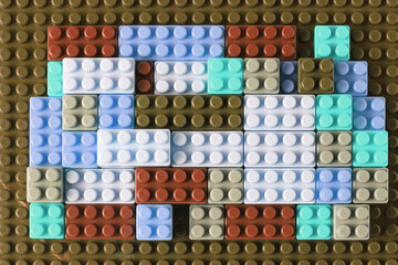 Small plastic building blocks on white background