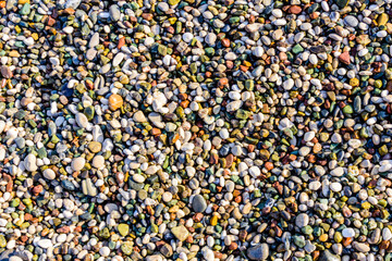 Texture of pebbles at the seaside. Natural background