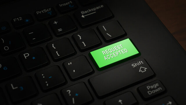 Close-up REQUEST ACCEPTED button with green color on a black laptop keyboard background. IT conceptual photo to accept or receive a task and demand by online. Contain document for company and service.