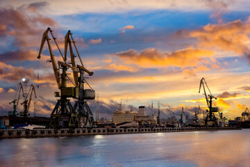 Sea cargo port at sunset. Sea cargo terminal. Port for loading ships. Ship port on a summer...