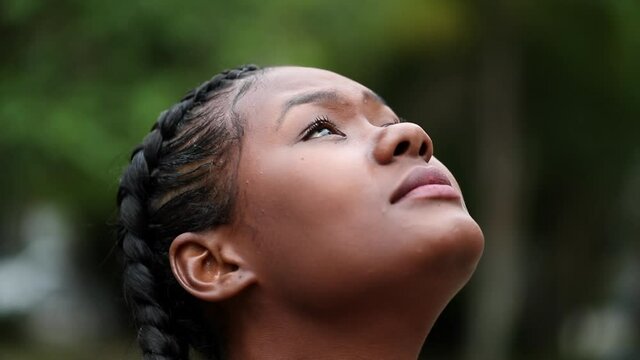 Contemplative black African girl face looking at sky