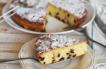 Piece of semolina pie on a wooden background with a napkin.Healthy homemade cakes.