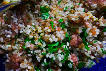 chopped raw meat with rice, onion and parsley