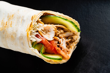 fajita wrap sandwich on the black background