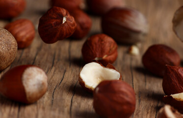 hazelnuts falling on a structural table made of cracked wood
