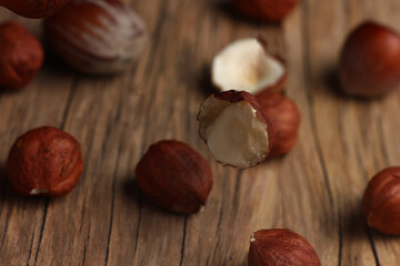 hazelnuts falling on a structural table made of cracked wood