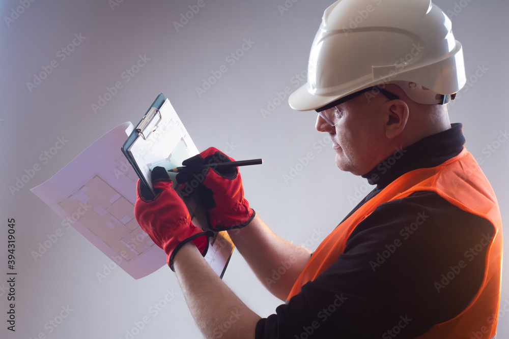 Poster the builder makes notes in the room plan. the architect makes amendments to the documentation. a man
