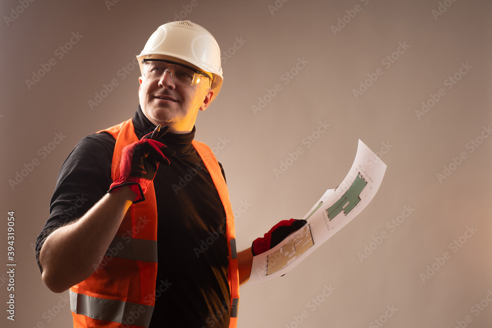 Poster engineer with project documentation for construction in hand. the man likes the developed project of