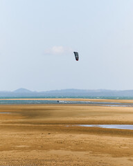 Kitesurfing on low tide at beach