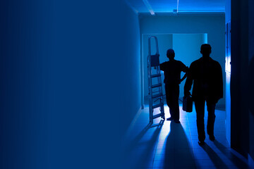 Electricians with a ladder. Installation of lighting. Repairs in the room. The builders with the...