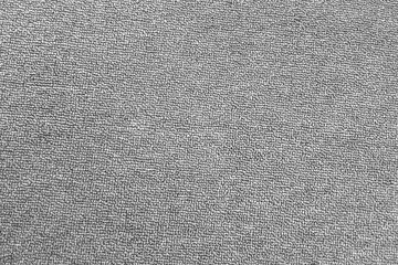 Fototapeta na wymiar The texture of the grey carpet. The background of grey cloth. Top view