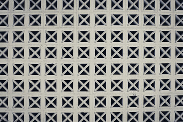 Wall with seamless geometric cross pattern. Toned image.