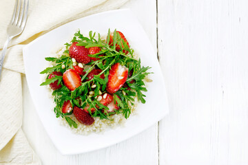 Salad of strawberry and couscous on light board top