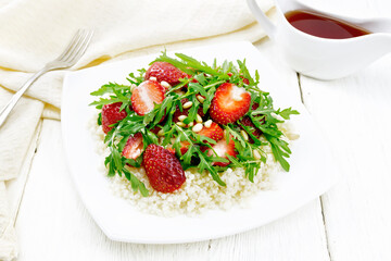 Salad of strawberry and couscous on wooden board