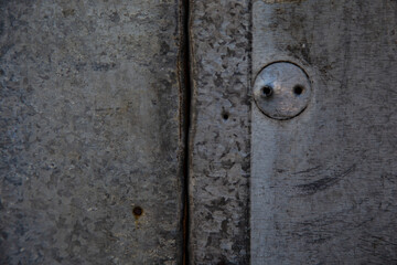 Garage corrosion on a rough metal wall or floor, scratches, air holes, nails, keys, holes, dents, pins.