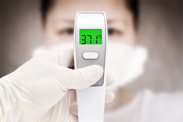 Covid-19 outbreak around the world. Digital thermometer for measuring body temperature display 37.1 degrees celsius
