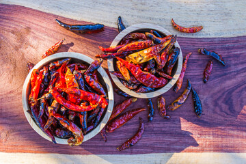 Chili burn in wooden bowl put on table. Top view