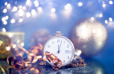 New Year's at midnight - Old clock with Christmas decoration and holiday lights