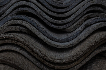 The texture of long layered waves, concrete slate roofing, solid tiles, aged, battered and cracked....