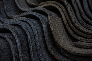 The texture of long layered waves, concrete slate roofing, solid tiles, aged, battered and cracked. Abstract gray retro background.