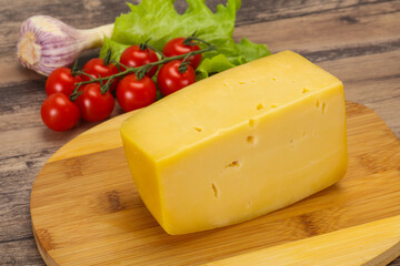 Hard yellow tasty cheese brick