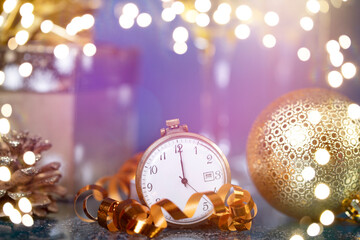 New Year's at midnight - Old clock with Christmas decoration, champagne and holiday lights