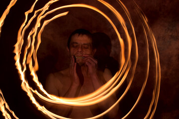 A young man plays the komus. Stylized image.