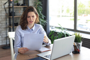 Happy entrepreneur woman sit at desk reading good news in post paper correspondence.