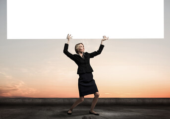 Beautiful woman in suit standing near banner