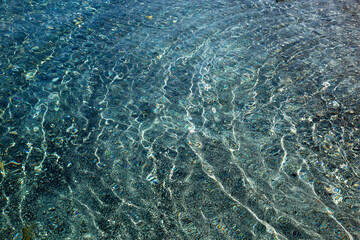 Patterns of water and sand by the sea.