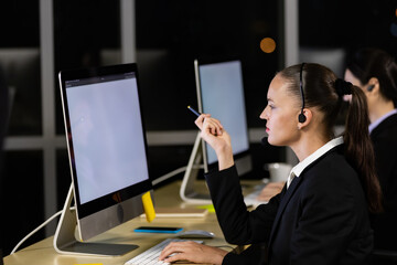 Caucasian young woman  working overtime late at night in call center office