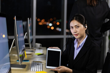 Portrait of smiling asian woman holding digital tablet for presentation work in office.
