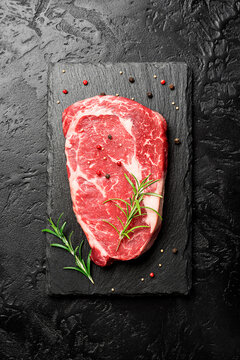 Raw fresh meat Ribeye steak entrecote of Black Angus Prime meat on black background. top view