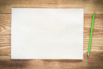 Sheet of paper lying on wooden table