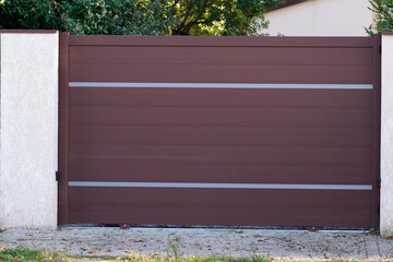 portal brown bordeaux metal of driveway entrance gates set in modern new house